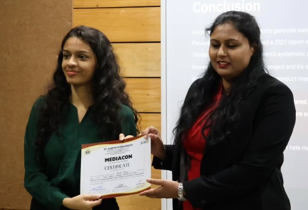 PES University journalism and mass communication student receiving a MEDIACON certificate at St Joseph's University