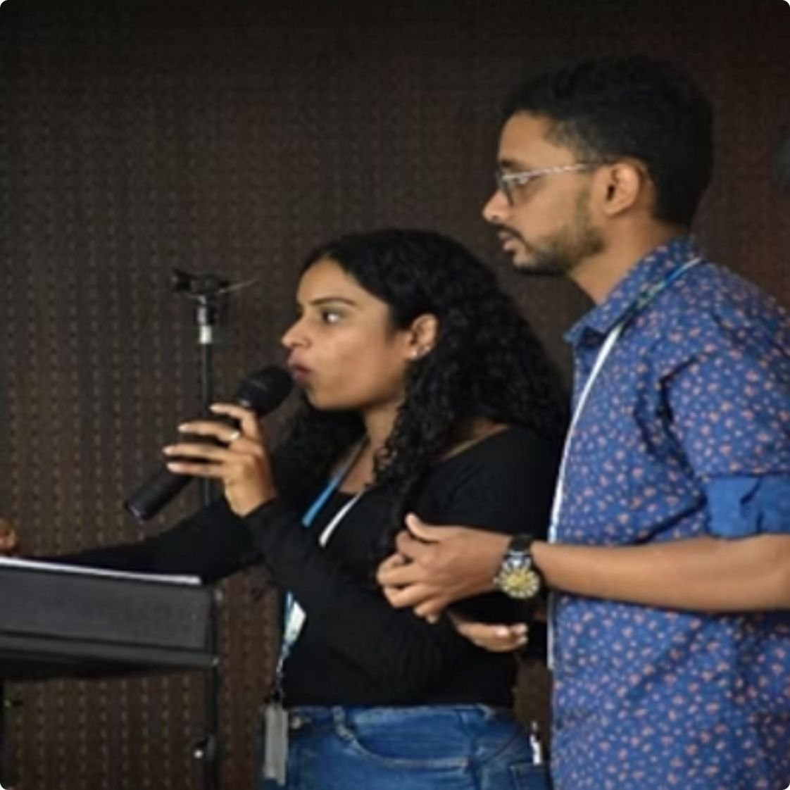 Students presenting with a microphone at a campus event at PES University Bengaluru