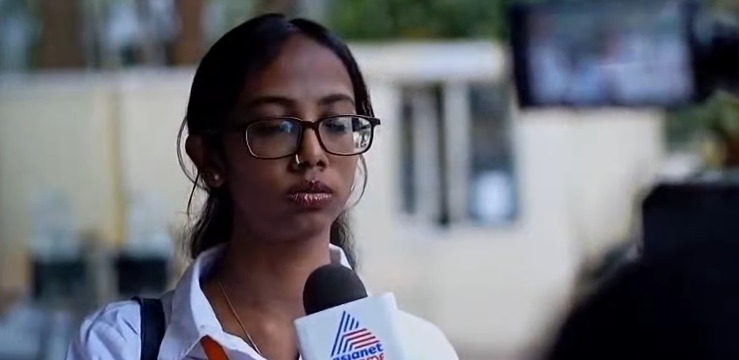 Journalism and mass communication student reporting on camera with an Asianet Suvarna News microphone